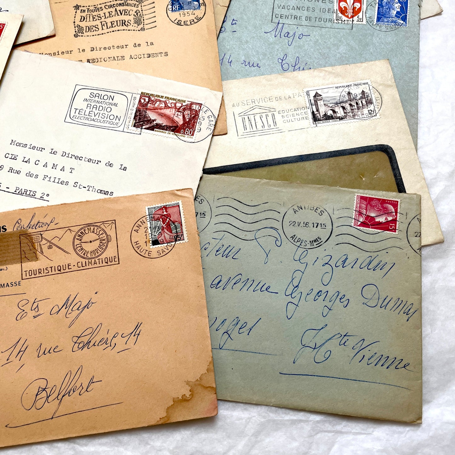 Lot of 20 French envelopes from the 1950s featuring various vintage stamps, postmarks, and handwritten addresses.