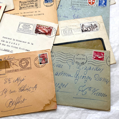 Lot of 20 French envelopes from the 1950s featuring various vintage stamps, postmarks, and handwritten addresses.
