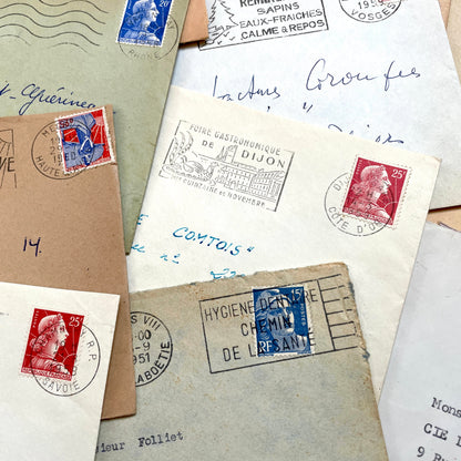 Lot of 20 French envelopes from the 1950s featuring various vintage stamps, postmarks, and handwritten addresses.