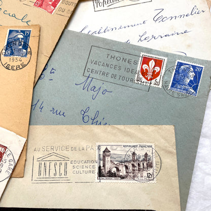 Lot of 20 French envelopes from the 1950s featuring various vintage stamps, postmarks, and handwritten addresses.