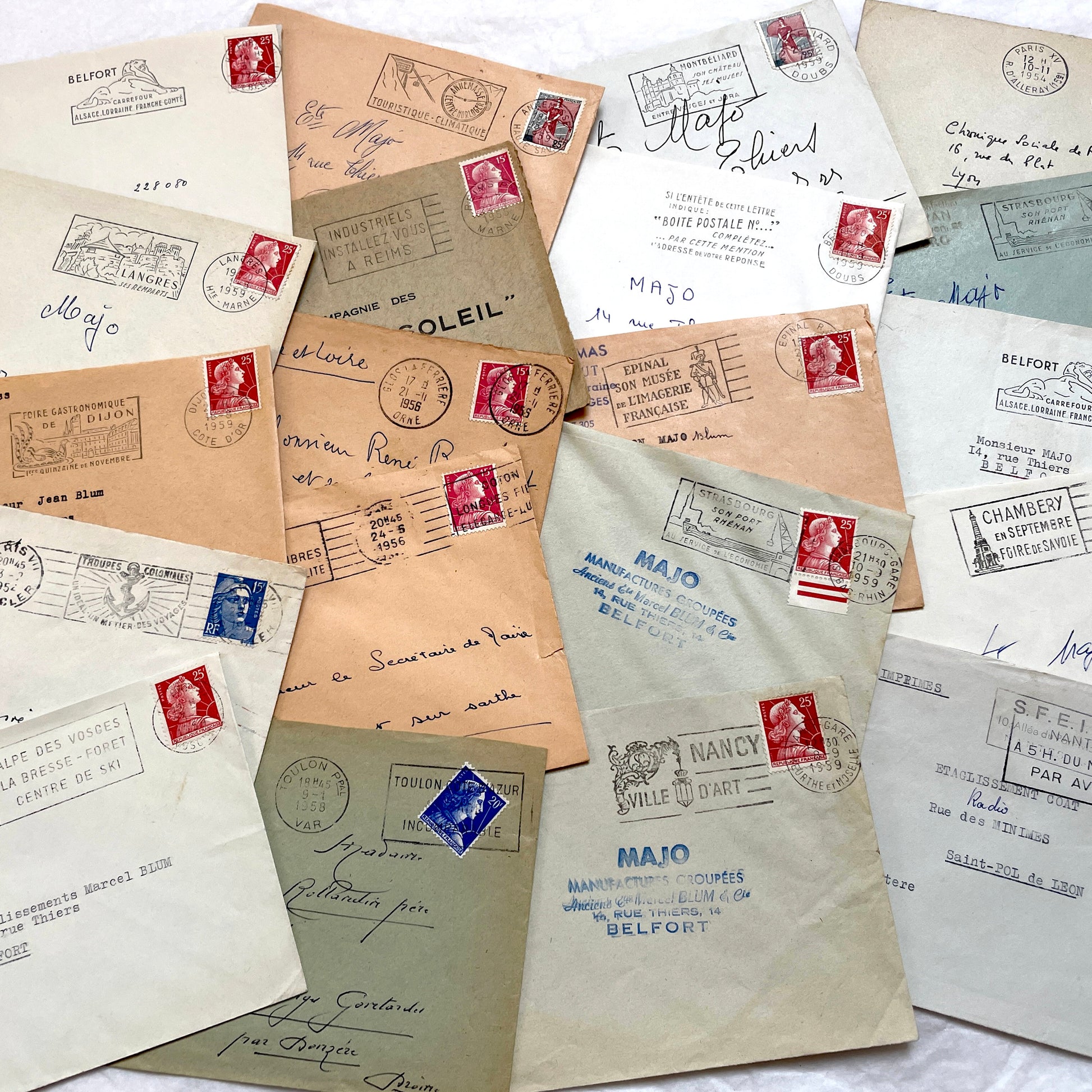 Batch of 20 French envelopes from the 1950s featuring various vintage stamps, postmarks, and handwritten addresses.