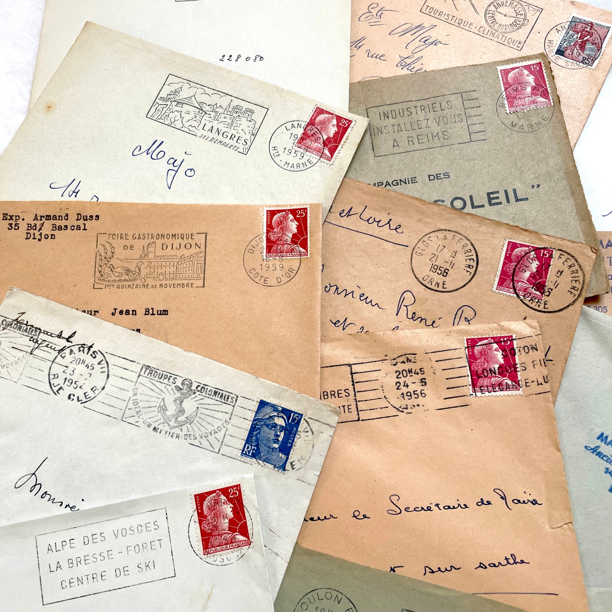 Batch of 20 French envelopes from the 1950s featuring various vintage stamps, postmarks, and handwritten addresses.