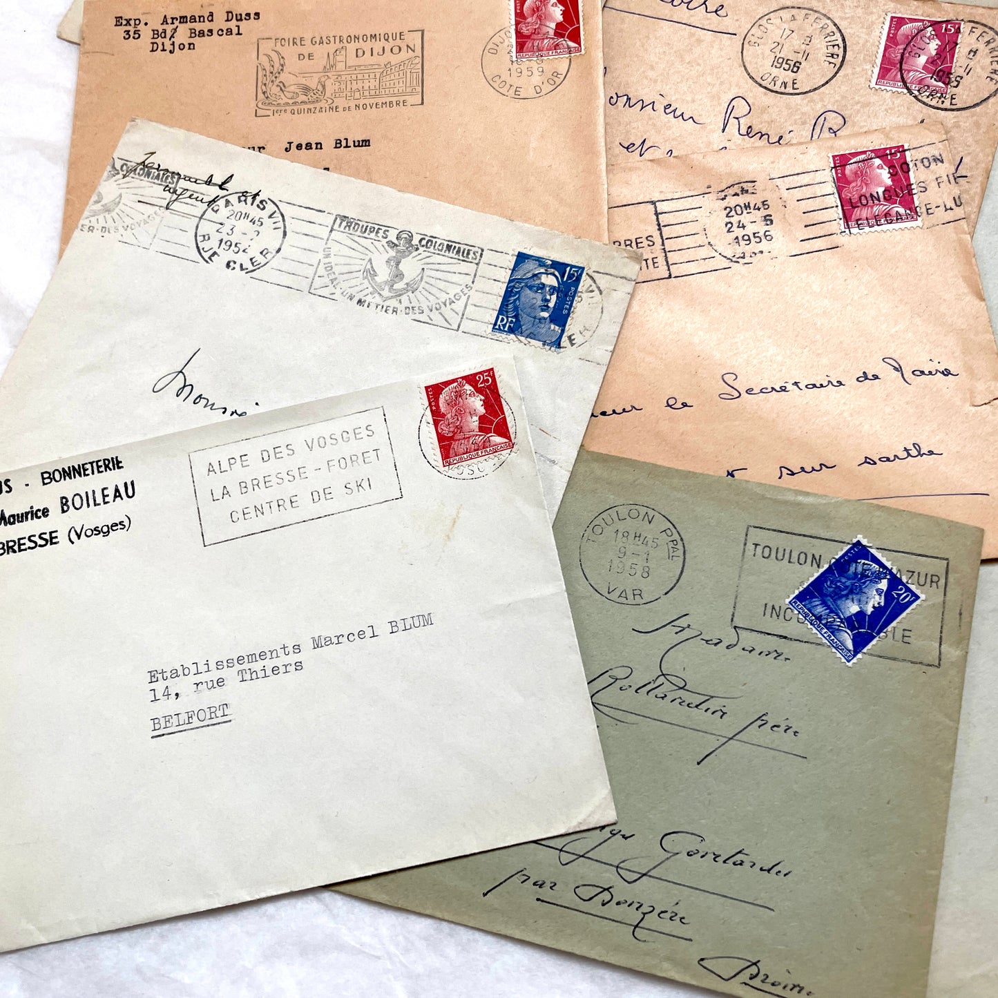 Batch of 20 French envelopes from the 1950s featuring various vintage stamps, postmarks, and handwritten addresses.