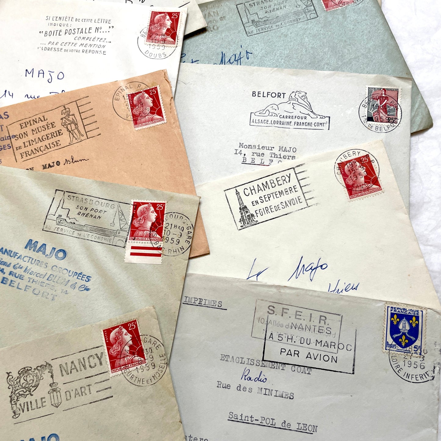 Batch of 20 French envelopes from the 1950s featuring various vintage stamps, postmarks, and handwritten addresses.