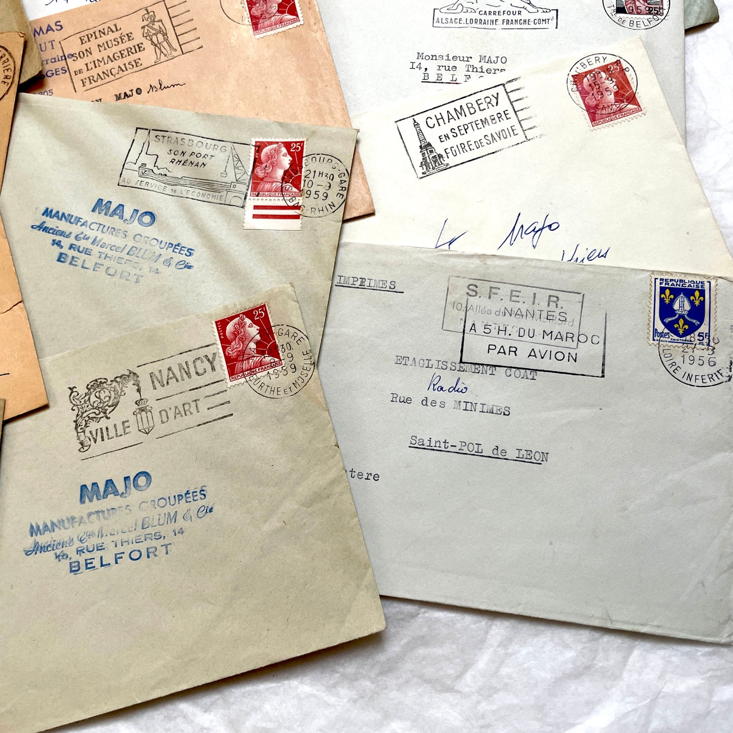 Batch of 20 French envelopes from the 1950s featuring various vintage stamps, postmarks, and handwritten addresses.