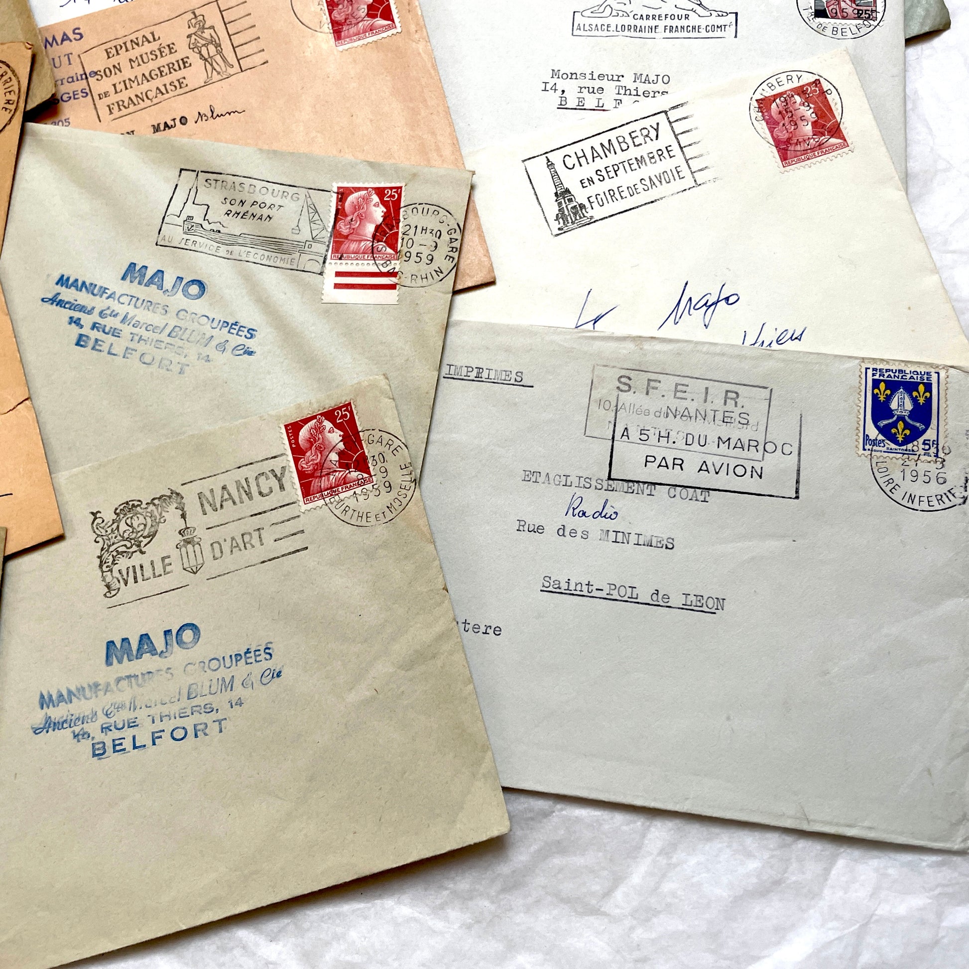 Batch of 20 French envelopes from the 1950s featuring various vintage stamps, postmarks, and handwritten addresses.