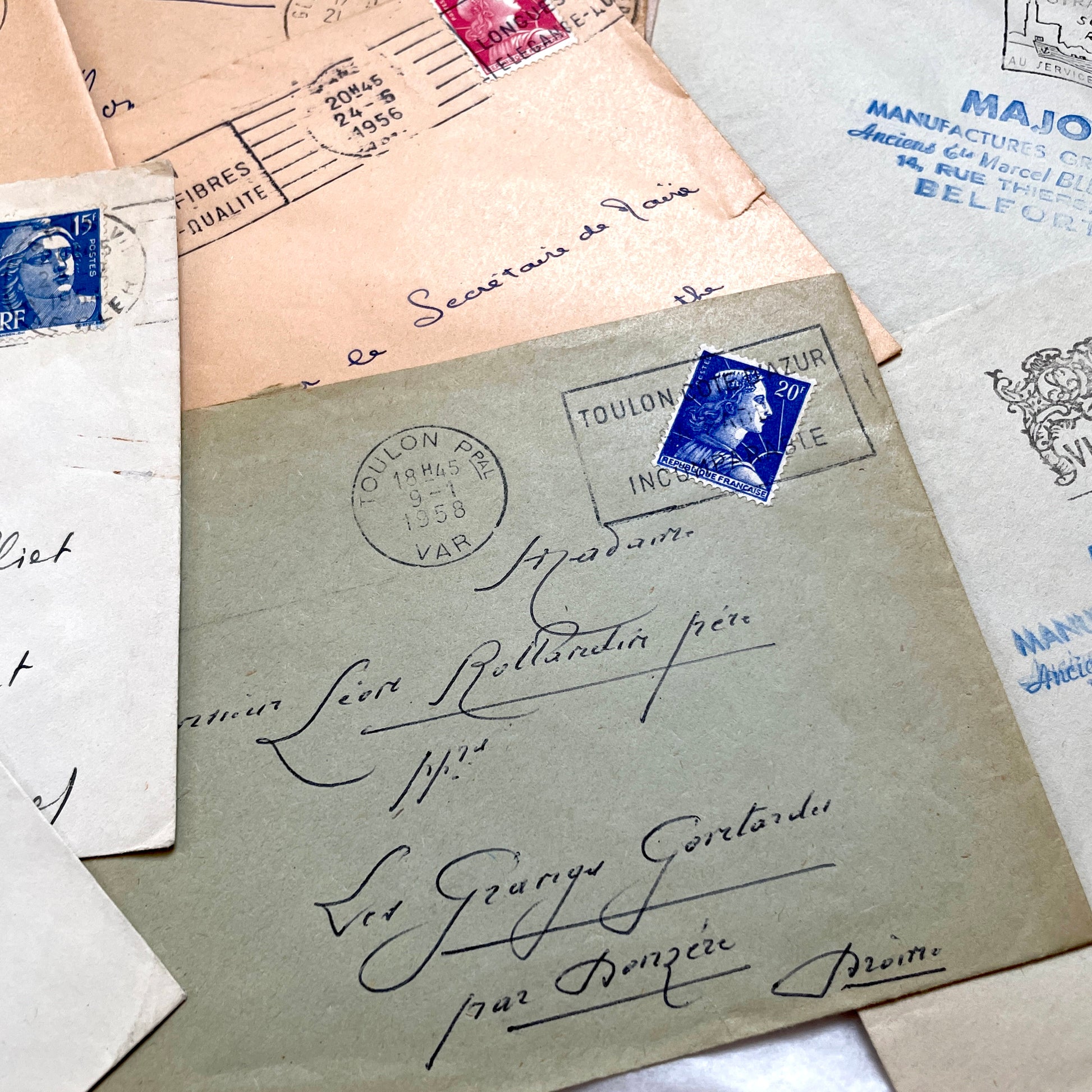 Batch of 20 French envelopes from the 1950s featuring various vintage stamps, postmarks, and handwritten addresses.