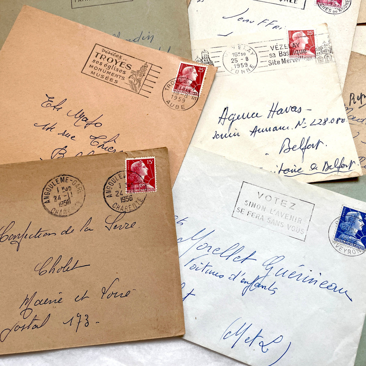 Lot of 20 1950s French envelopes with vintage stamps and detailed postmarks, showing historical European mail.