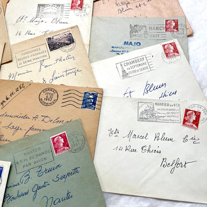 Lot of 20 1950s French envelopes with vintage stamps and detailed postmarks, showing historical European mail.