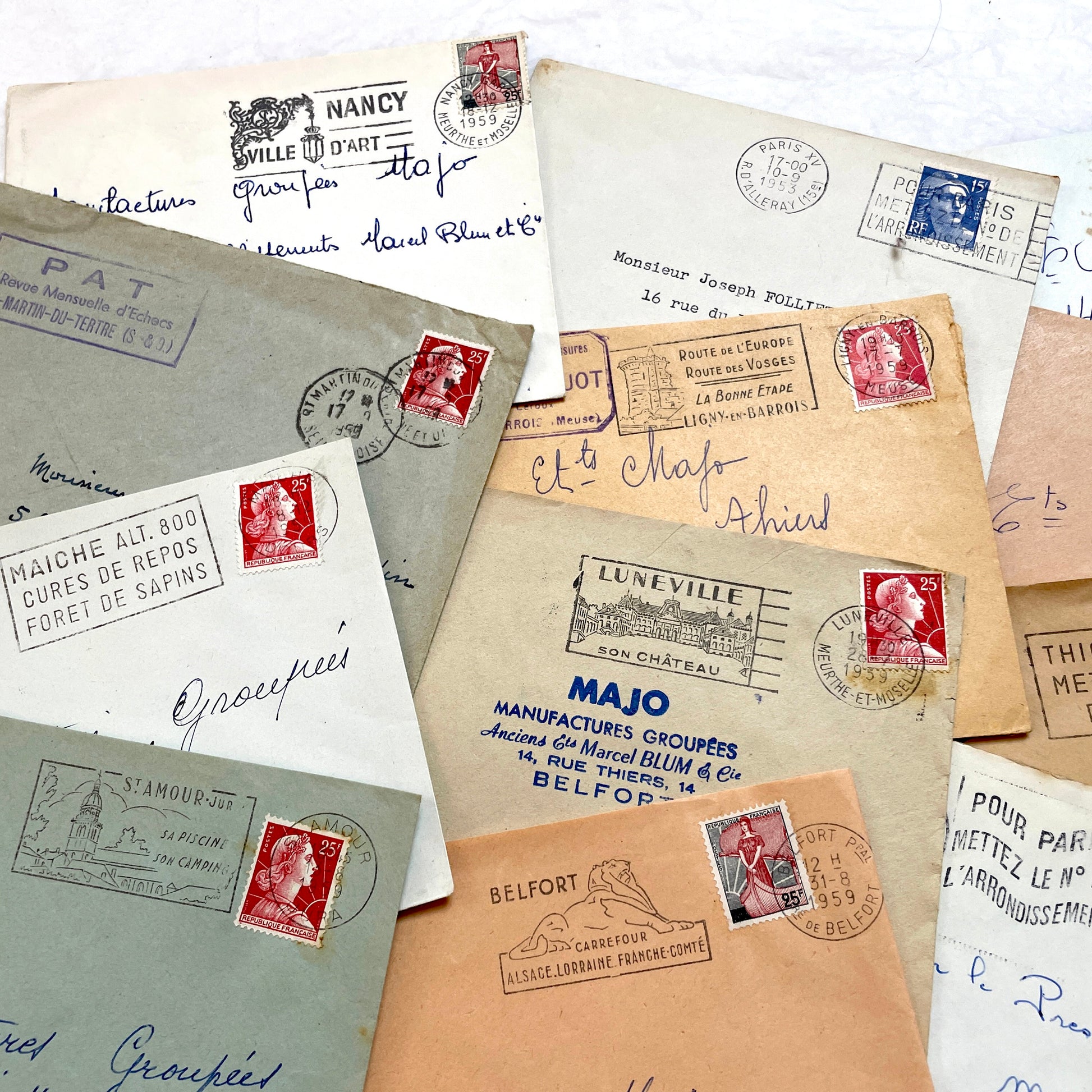 Lot of 20 vintage French envelopes from the 1950s, featuring various postmarks and stamps, ideal for collectors.