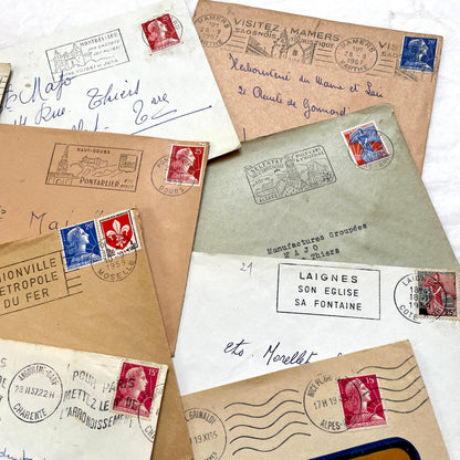 Lot of 20 vintage French envelopes from the 1950s, featuring various postmarks and stamps, ideal for collectors.
