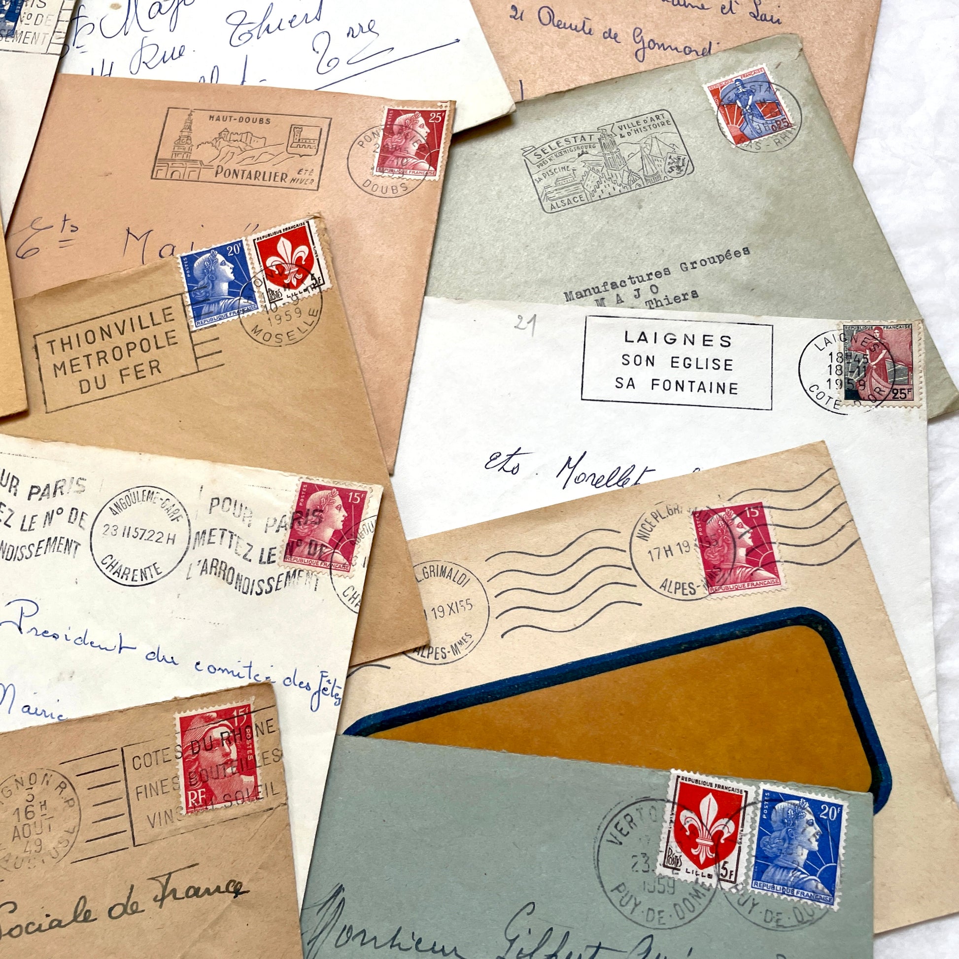 Lot of 20 vintage French envelopes from the 1950s, featuring various postmarks and stamps, ideal for collectors.