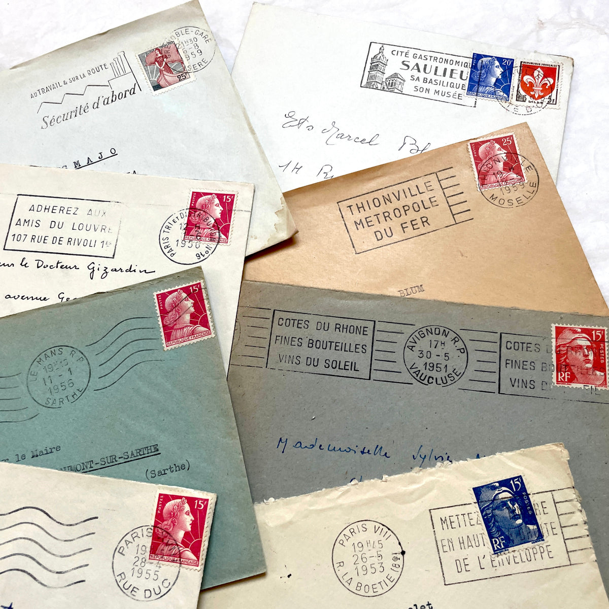 Lot of 20 French envelopes from the 1950s, featuring various postal stamps, handwritten addresses, and distinct postmarks.