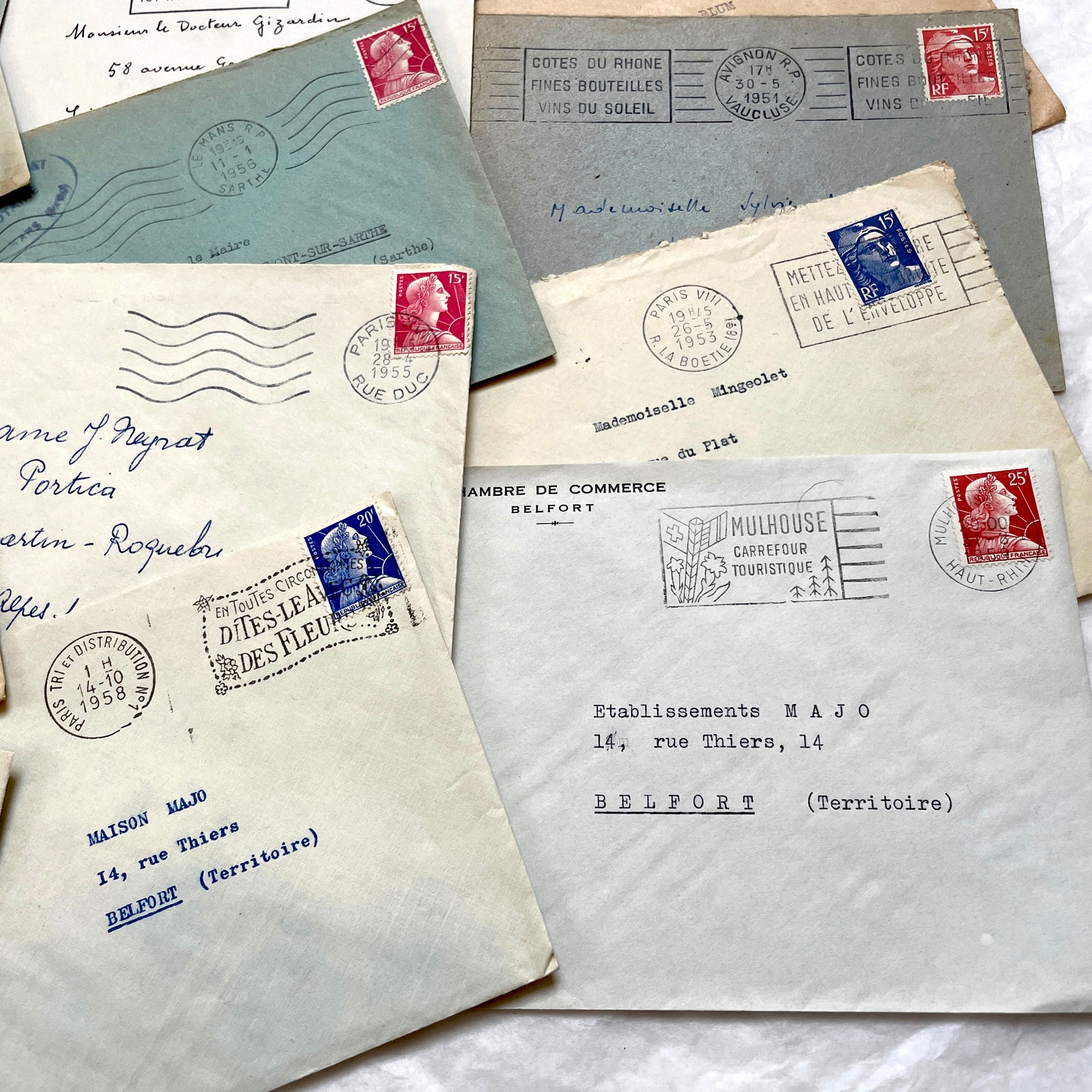 Lot of 20 French envelopes from the 1950s, featuring various postal stamps, handwritten addresses, and distinct postmarks.