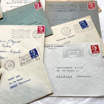 Lot of 20 French envelopes from the 1950s, featuring various postal stamps, handwritten addresses, and distinct postmarks.