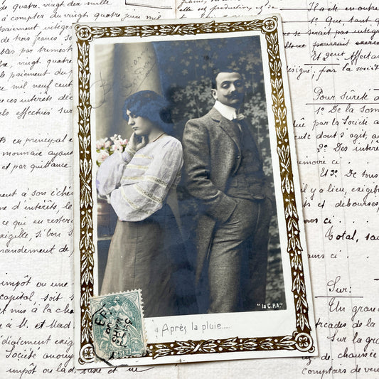 1900s - Vintage French Hand-Colored Photo Postcard - Belle Epoque Couple - 'Après La Pluie' Caption - Ornate Gold Border