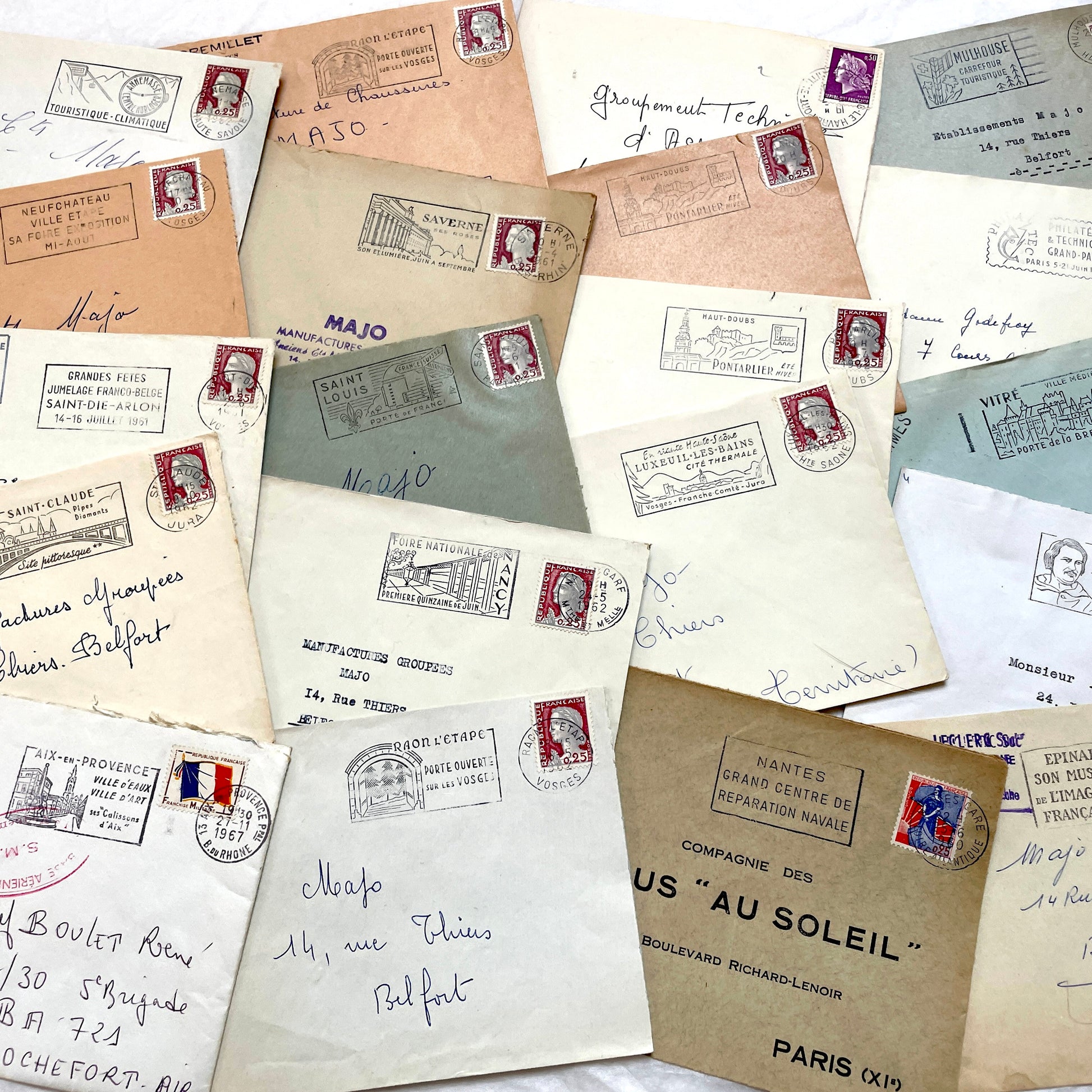 A collection of 20 French envelopes from the 1960s, featuring various postage stamps and unique regional postmarks.