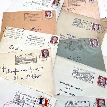 A collection of 20 French envelopes from the 1960s, featuring various postage stamps and unique regional postmarks.