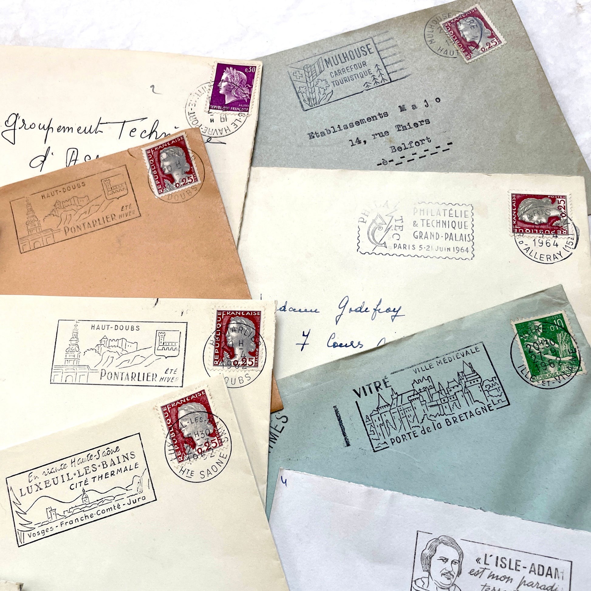 A collection of 20 French envelopes from the 1960s, featuring various postage stamps and unique regional postmarks.