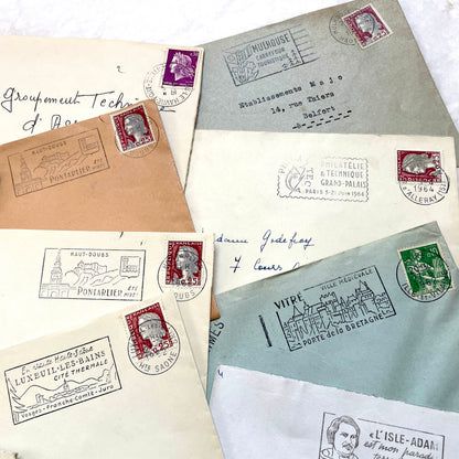 A collection of 20 French envelopes from the 1960s, featuring various postage stamps and unique regional postmarks.