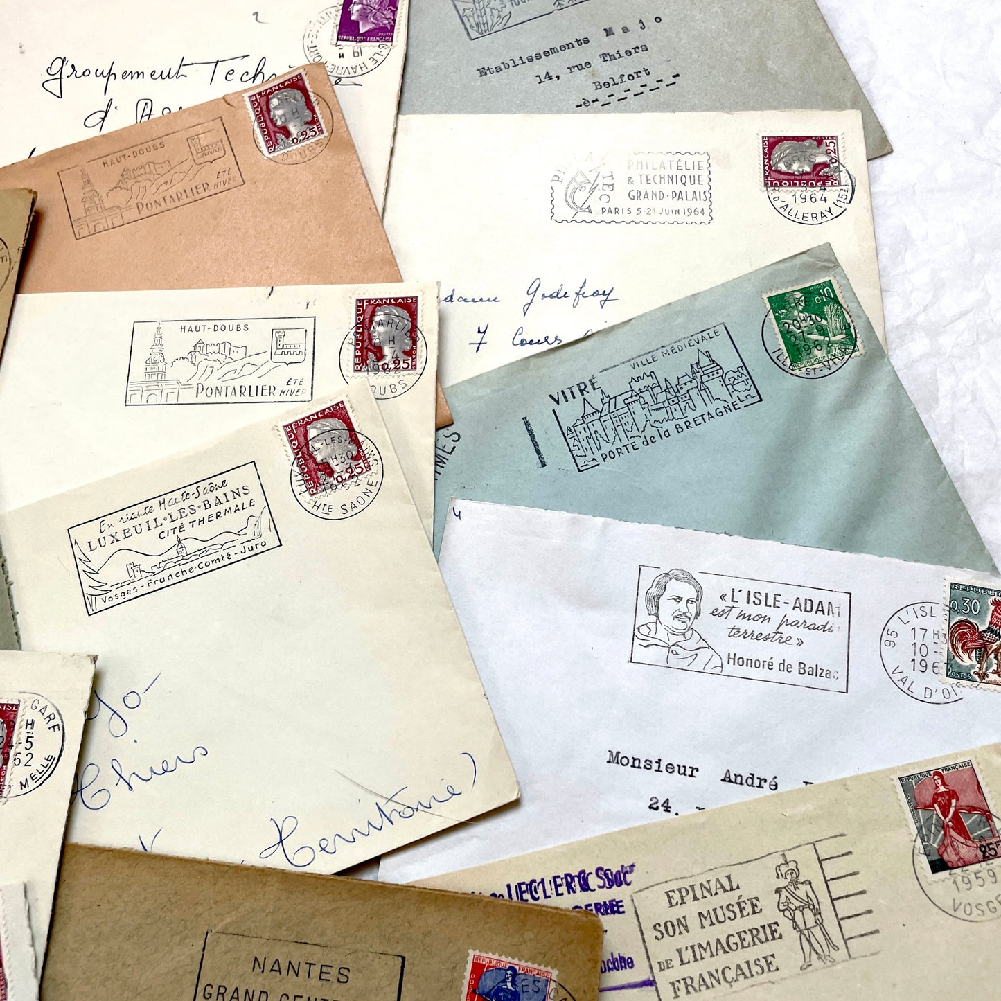 A collection of 20 French envelopes from the 1960s, featuring various postage stamps and unique regional postmarks.
