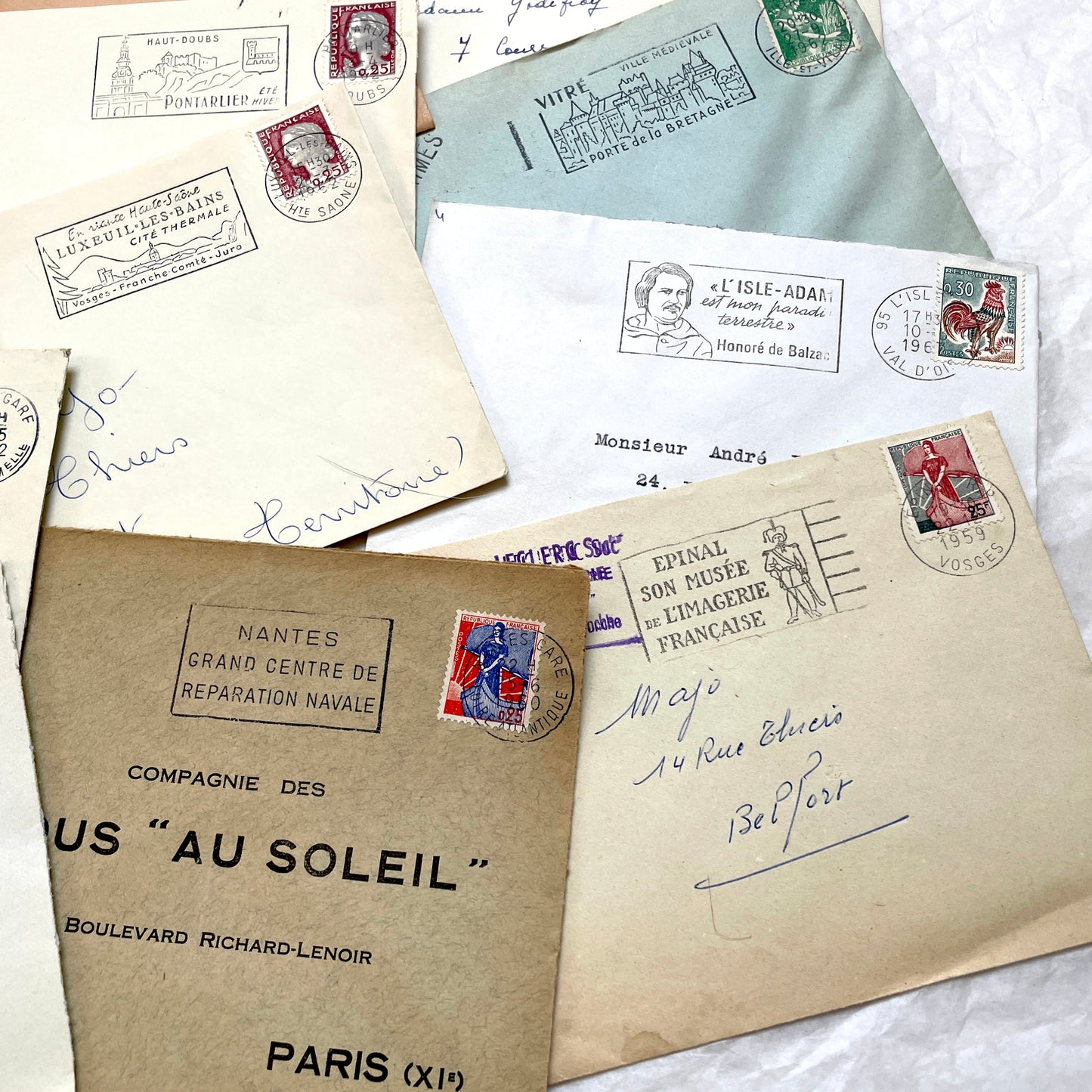 A collection of 20 French envelopes from the 1960s, featuring various postage stamps and unique regional postmarks.