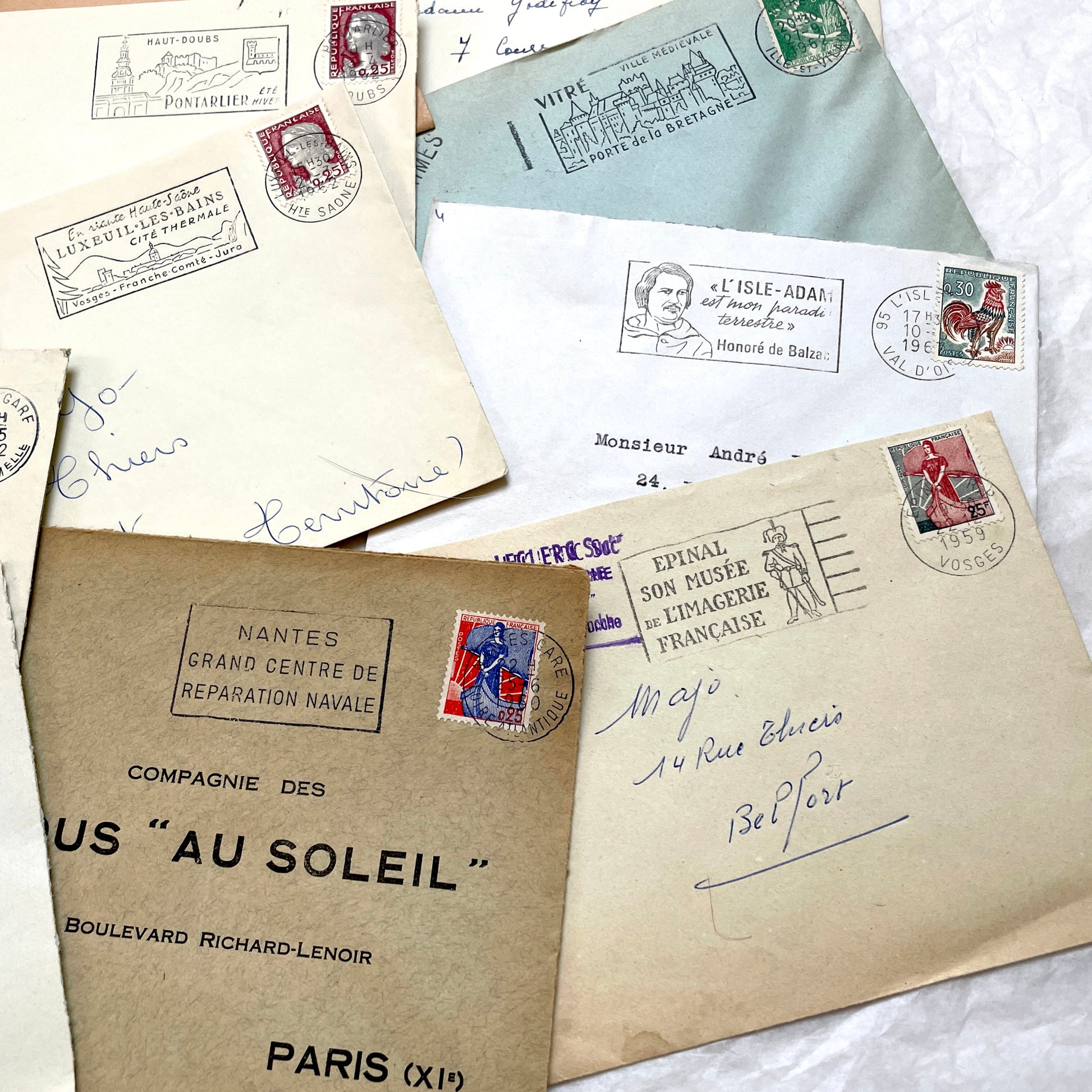 A collection of 20 French envelopes from the 1960s, featuring various postage stamps and unique regional postmarks.