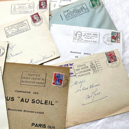 A collection of 20 French envelopes from the 1960s, featuring various postage stamps and unique regional postmarks.