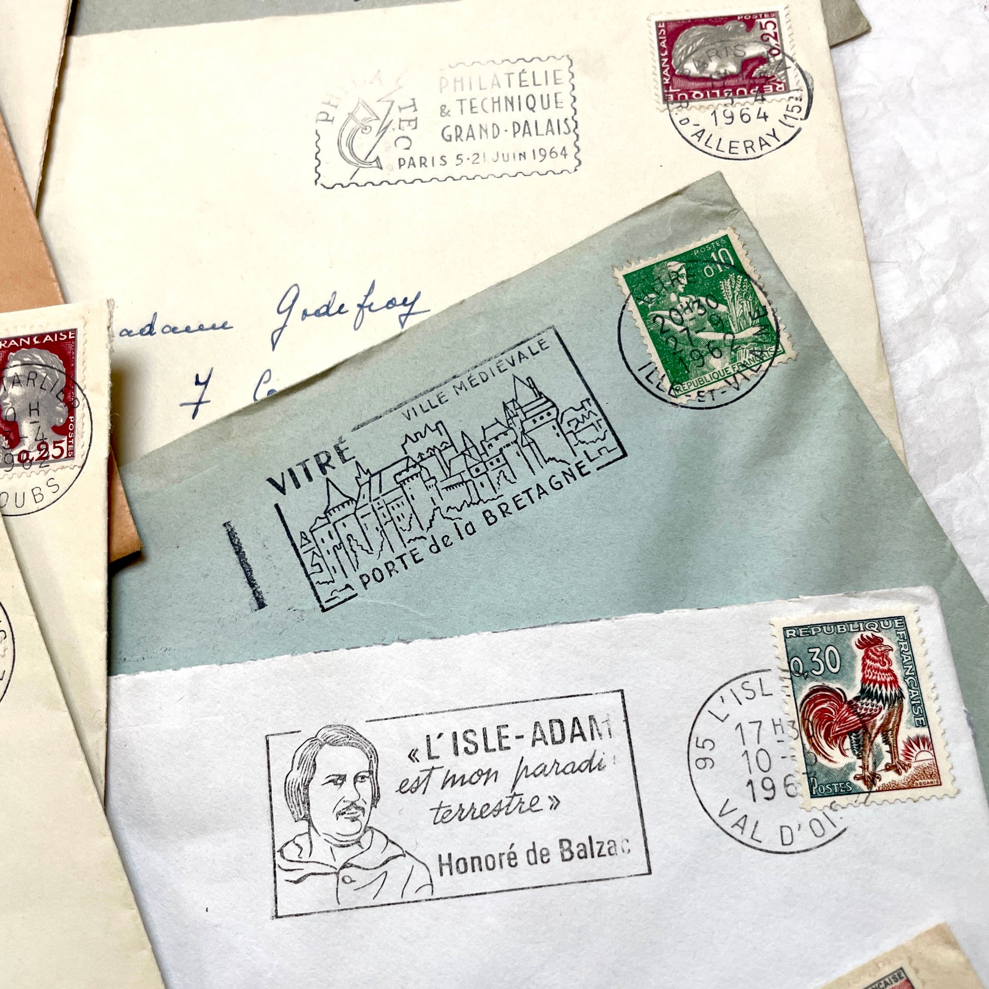 A collection of 20 French envelopes from the 1960s, featuring various postage stamps and unique regional postmarks.