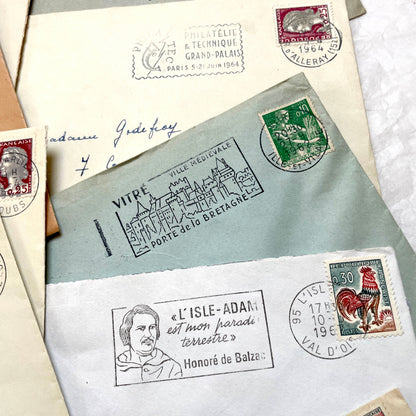 A collection of 20 French envelopes from the 1960s, featuring various postage stamps and unique regional postmarks.