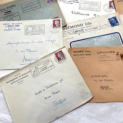 1960s French envelope lot featuring various postmarks, vintage stamps, and printed company addresses.