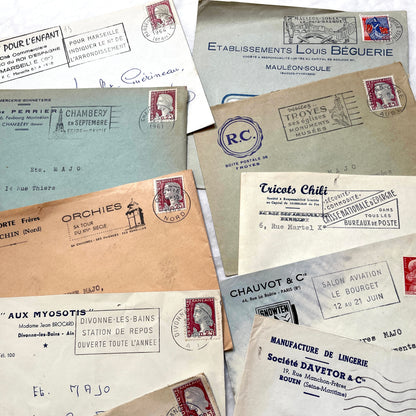 1960s French envelope lot featuring various postmarks, vintage stamps, and printed company addresses.