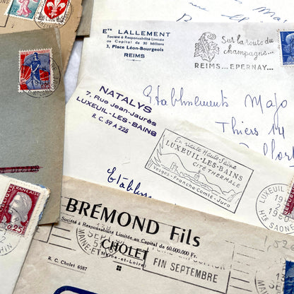1960s French envelope lot featuring various postmarks, vintage stamps, and printed company addresses.