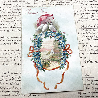 1900s - Vintage French Bonne Fete Postcard - Doves Under Umbrella - Floral Wreath - Forget-Me-Nots - Cottage Scene - Antique Greeting Card