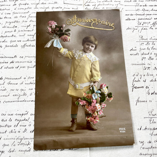 1910s - Vintage French Anniversaire Postcard - Adorable Young Child with Hand-Colored Flower Bouquets - Sepia Photo Ephemera Card