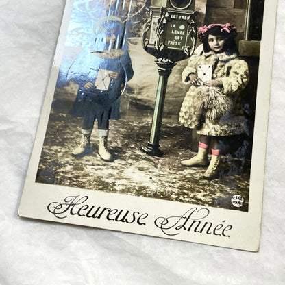 1910s - Vintage French Postcard - Two Children with Mailbox - Heureuse Année - Hand-Tinted Collectible - Antique Ephemera