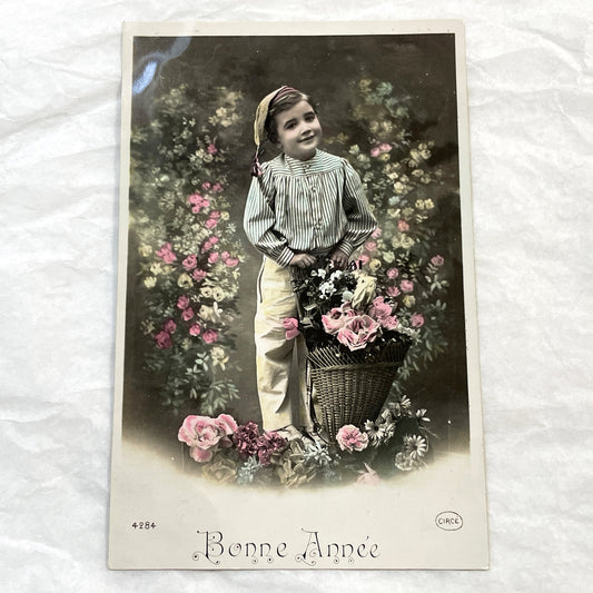 1910s - Vintage French Postcard - Adorable Hand-Colored Portrait of a Young Child with a Flower Basket - Bonne Année Greeting