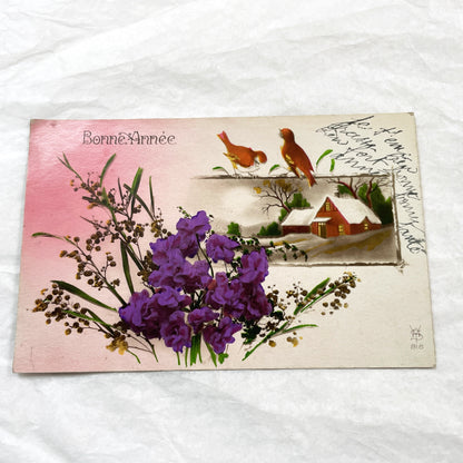 1910s - French New Year Postcard - Vintage Winter Scene with Birds and Snow-Covered Cottage - Vibrant Purple Flowers - Greeting Card