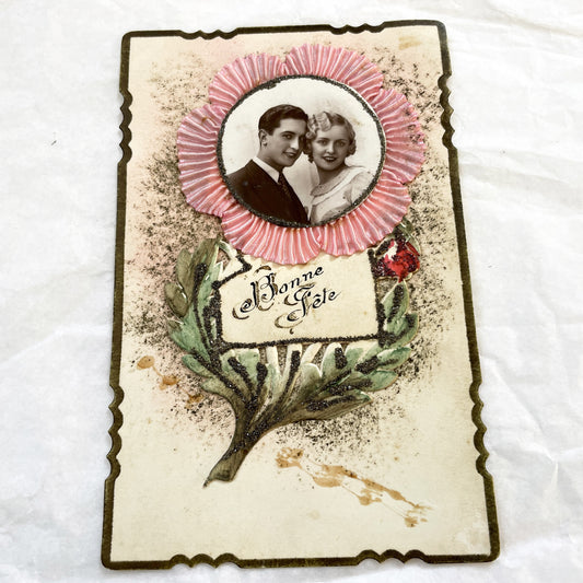 1930s - Vintage French Bonne Fête Greeting Card - Young Couple Photo - Embossed Pink Ribbon - Green Glitter Laurel - Keepsake Ephemera