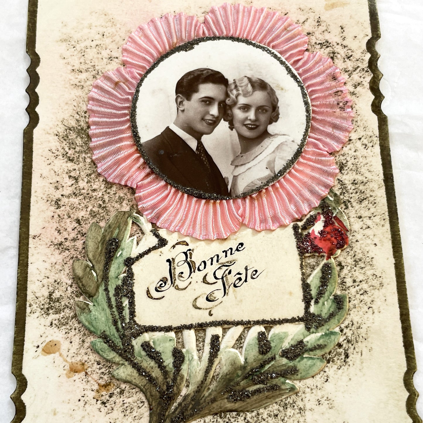 1930s - Vintage French Bonne Fête Greeting Card - Young Couple Photo - Embossed Pink Ribbon - Green Glitter Laurel - Keepsake Ephemera