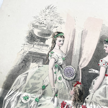 1860s French fashion plate depicting two women in elaborate ball gowns and a child in a red and white striped dress.