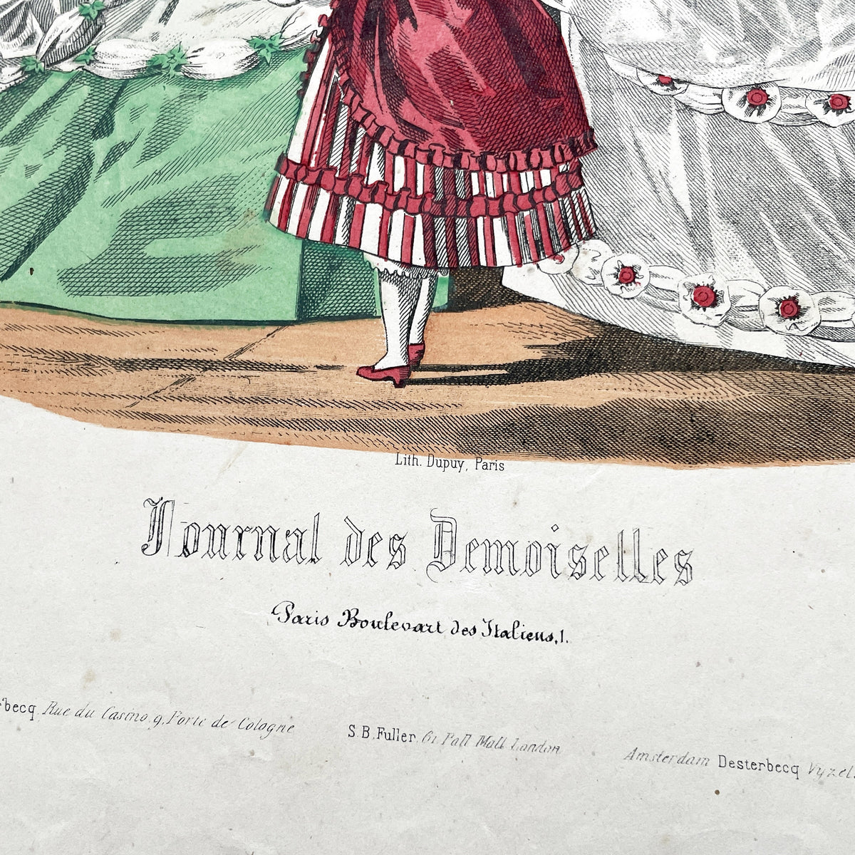 1860s French fashion plate depicting two women in elaborate ball gowns and a child in a red and white striped dress.