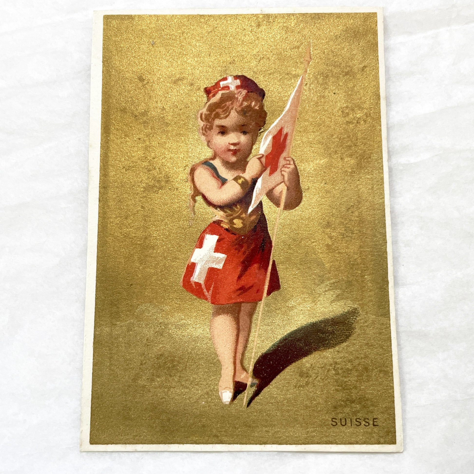 1900s - Vintage Chromo - Little Swiss Girl in Traditional Dress Holding Flag - Golden Background - Collectible Ephemera