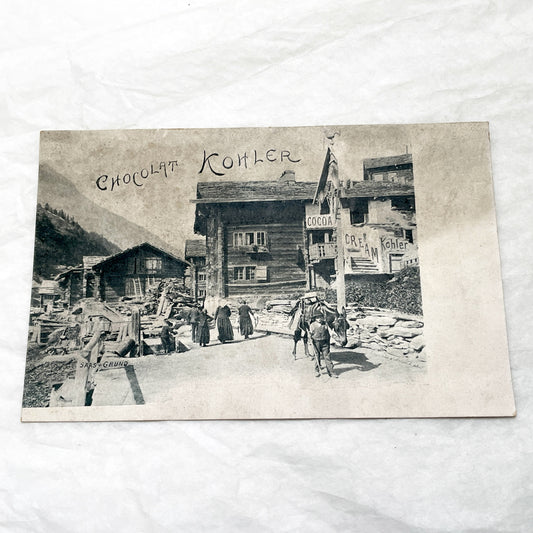 1900s - Vintage Swiss Saas-Grund Village Scene Postcard with Chocolat Kohler Advertising and Alpine Lifestyle - Collectible Ephemera.