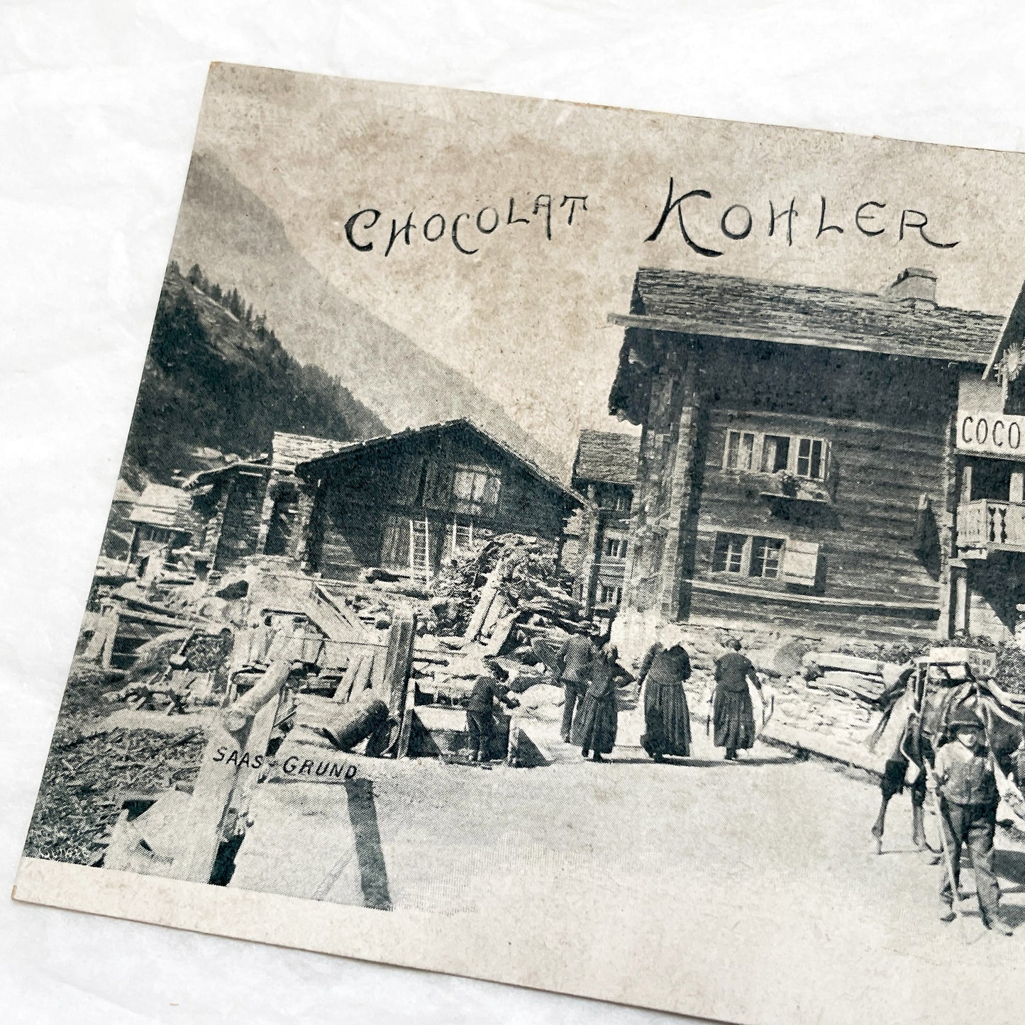 1900s - Vintage Swiss Saas-Grund Village Scene Postcard with Chocolat Kohler Advertising and Alpine Lifestyle - Collectible Ephemera.