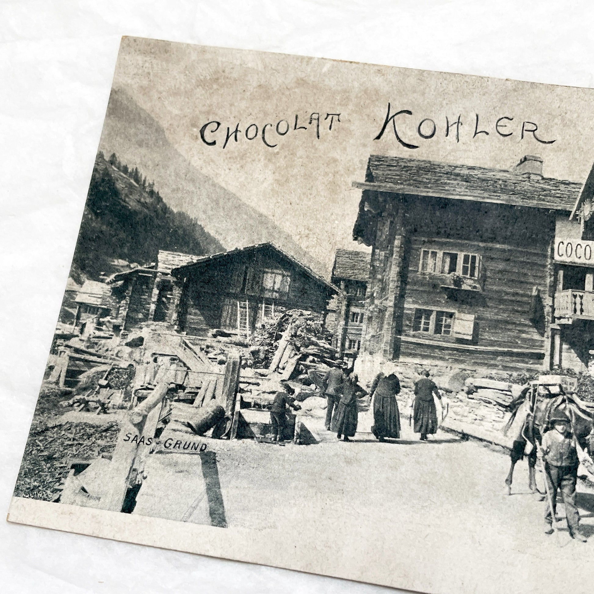 1900s - Vintage Swiss Saas-Grund Village Scene Postcard with Chocolat Kohler Advertising and Alpine Lifestyle - Collectible Ephemera.