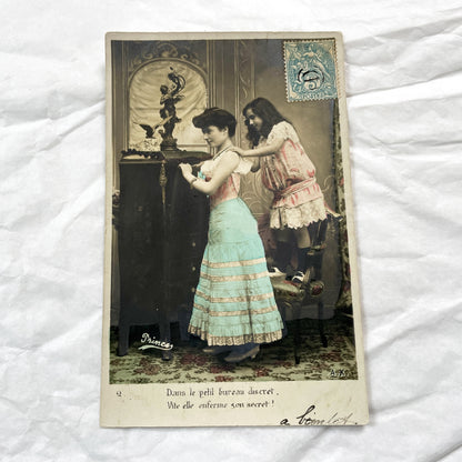 1900s - French Hand Colored Postcard - Young Woman Locking Secret in Discreet Cabinet - Charming Belle Epoque Genre Scene