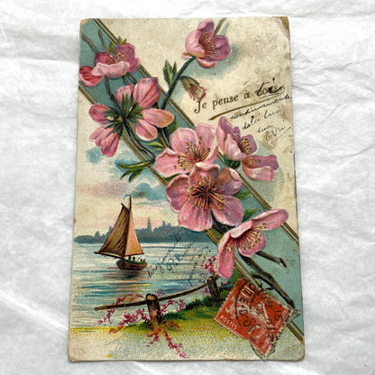 1900s French postcard with pink cherry blossoms, a sailboat, and a vintage French stamp