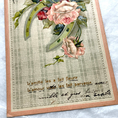 1900s French postcard with embossed pink roses and a green lucky horseshoe on a plaid background.