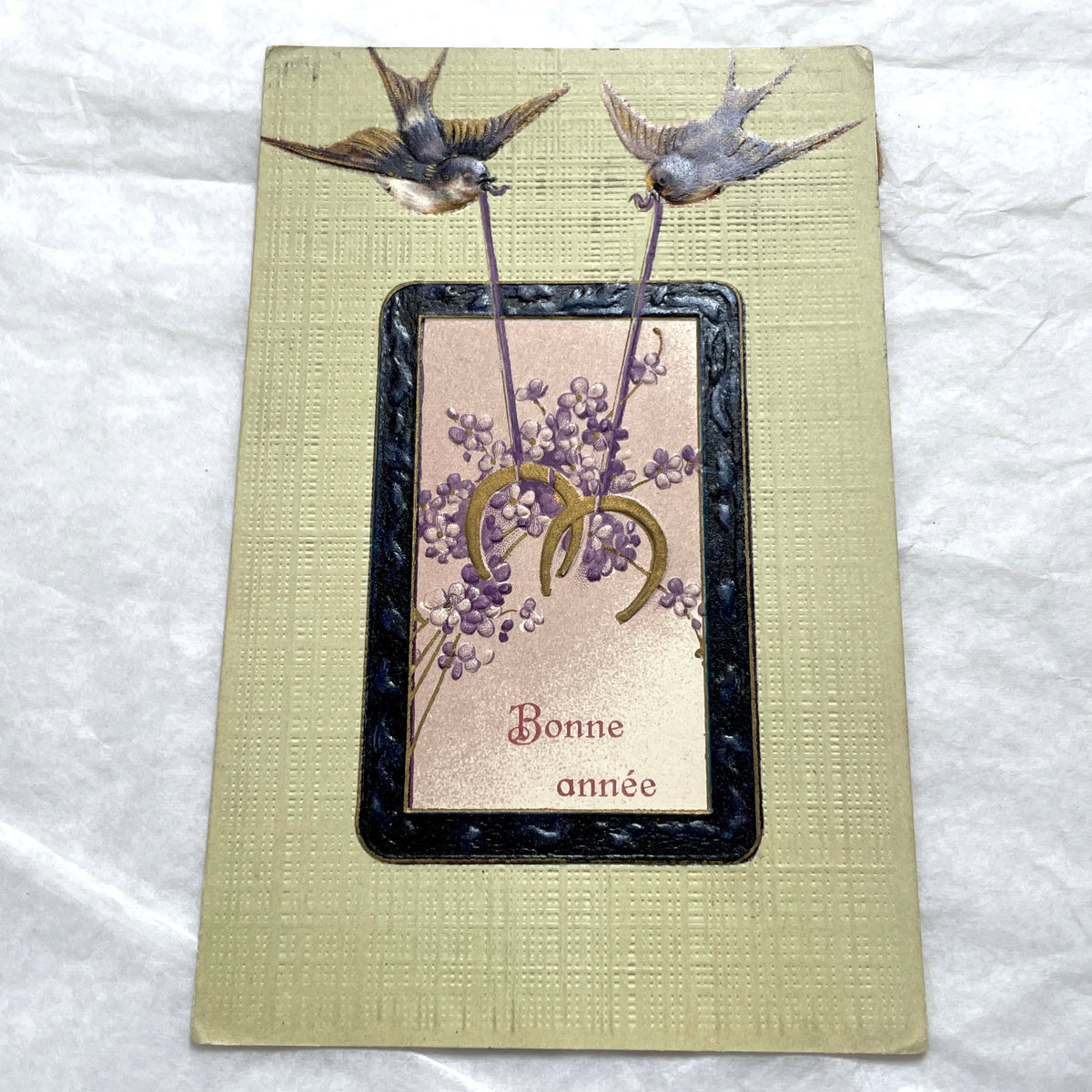 1900s New Year postcard with swallows carrying a good luck horseshoe and 'Bonne année' French text.
